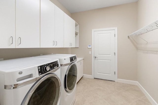 laundry room featuring cabinet space, independent washer and dryer, and baseboards