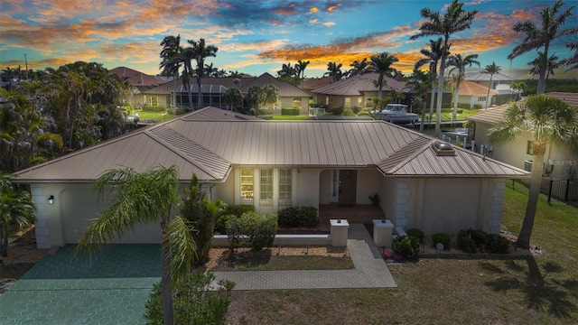 3824 Aves Island Ct, Punta Gorda, FL 33950 - view of front of property featuring a garage, a residential view, metal roof, and stucco siding