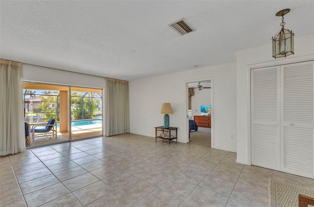3824 Aves Island Ct, Punta Gorda, FL 33950 - unfurnished room featuring a textured ceiling, light tile patterned floors, ceiling fan, and visible vents