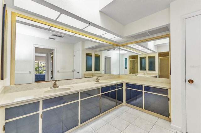 3824 Aves Island Ct, Punta Gorda, FL 33950 - bathroom with a sink, a shower stall, tile patterned flooring, and double vanity