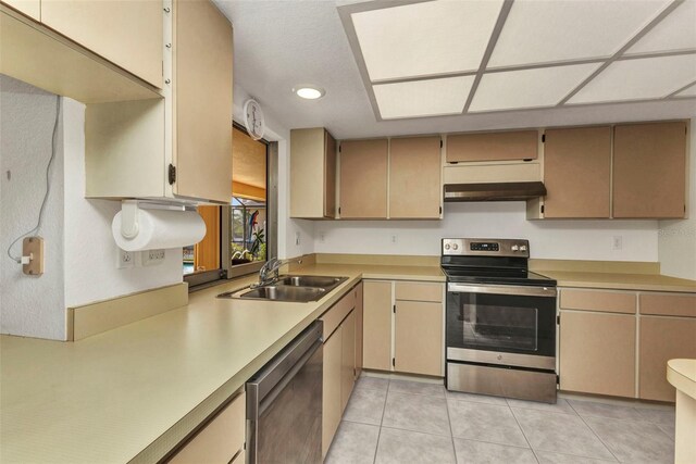 3824 Aves Island Ct, Punta Gorda, FL 33950 - kitchen with light tile patterned floors, light countertops, under cabinet range hood, appliances with stainless steel finishes, and a sink