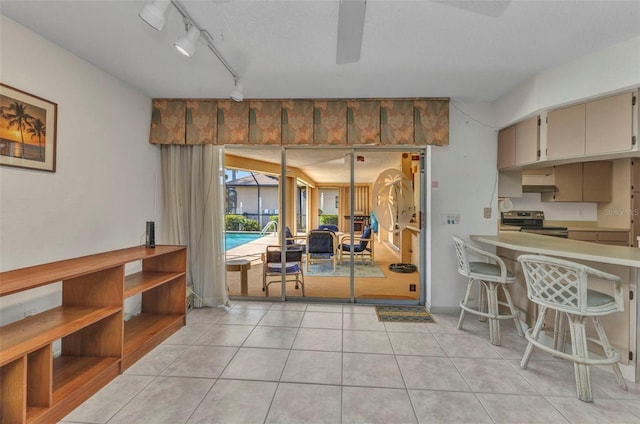 3824 Aves Island Ct, Punta Gorda, FL 33950 - dining area featuring track lighting, ceiling fan, and light tile patterned flooring