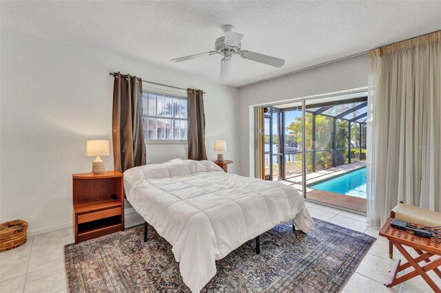 3824 Aves Island Ct, Punta Gorda, FL 33950 - bedroom with baseboards, access to exterior, a textured ceiling, and light tile patterned flooring