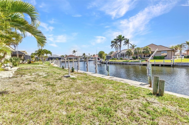 3824 Aves Island Ct, Punta Gorda, FL 33950 - dock area with a water view, a residential view, boat lift, and a lawn