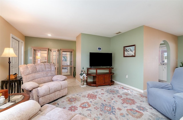 3187 Elkcam Blvd, Port Charlotte, FL 33952 - living area featuring arched walkways, baseboards, and light tile patterned flooring