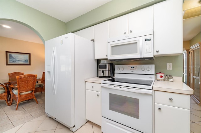 3187 Elkcam Blvd, Port Charlotte, FL 33952 - kitchen with white appliances, light countertops, light tile patterned floors, and white cabinetry