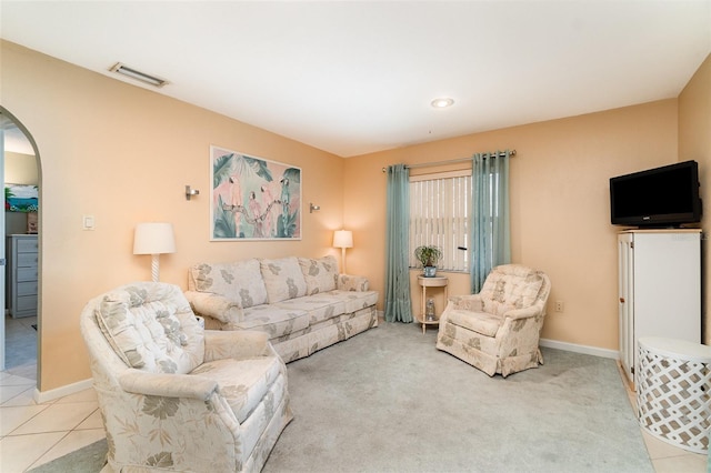 3187 Elkcam Blvd, Port Charlotte, FL 33952 - living area featuring arched walkways, light carpet, and baseboards