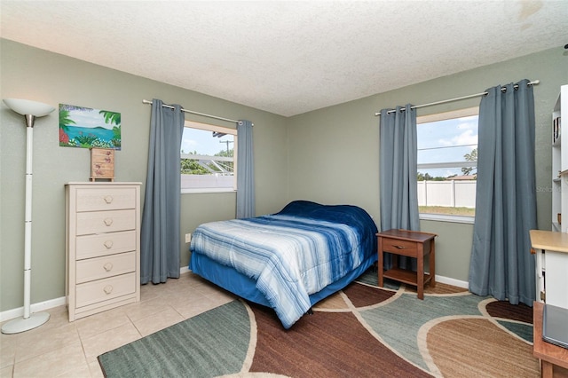 3187 Elkcam Blvd, Port Charlotte, FL 33952 - bedroom featuring a textured ceiling, baseboards, and light tile patterned floors