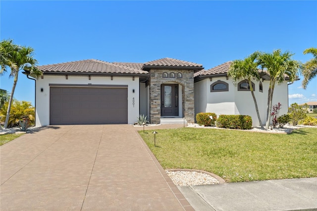 mediterranean / spanish house with concrete driveway, stucco siding, an attached garage, and a tile roof