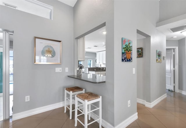 interior space featuring baseboards and tile patterned flooring