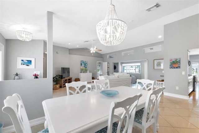 dining room with ceiling fan with notable chandelier, light tile patterned floors, visible vents, and a wealth of natural light