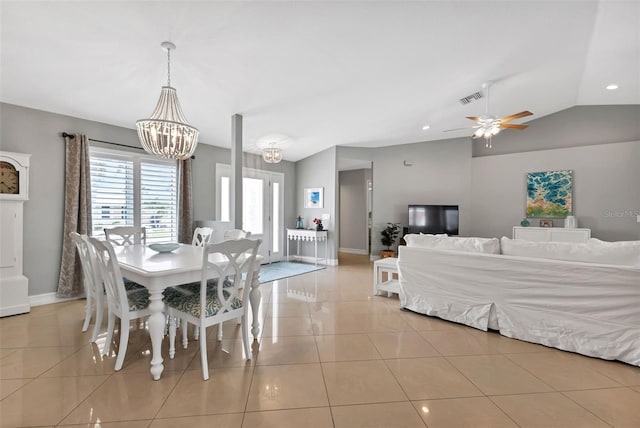 dining room with ceiling fan with notable chandelier, tile patterned floors, baseboards, and lofted ceiling