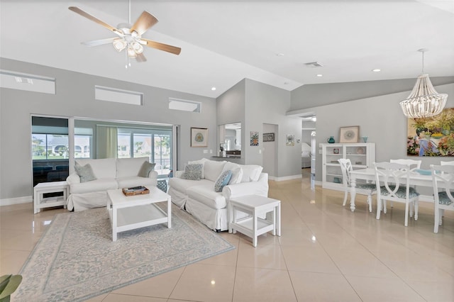 living room with light tile patterned floors, visible vents, ceiling fan with notable chandelier, and baseboards