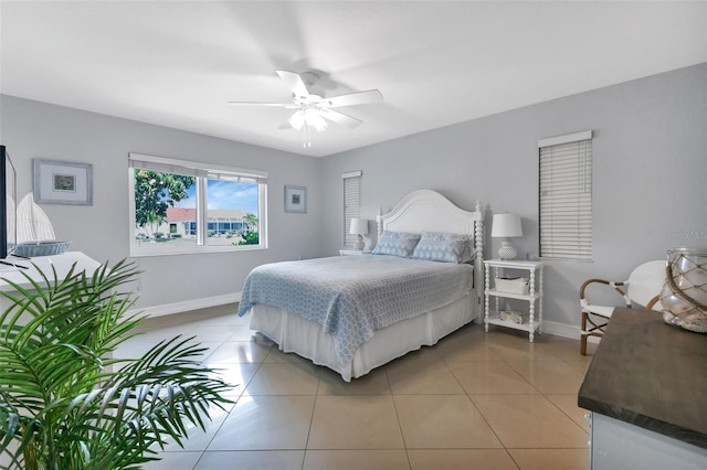 bedroom featuring ceiling fan, baseboards, and light tile patterned flooring