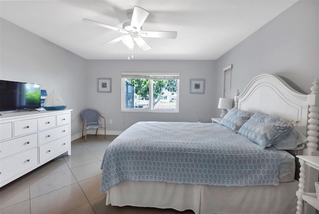 bedroom featuring light tile patterned floors, baseboards, and ceiling fan