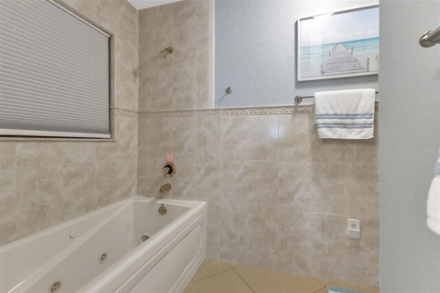full bathroom with tile patterned flooring, tile walls, a tub with jets, and walk in shower