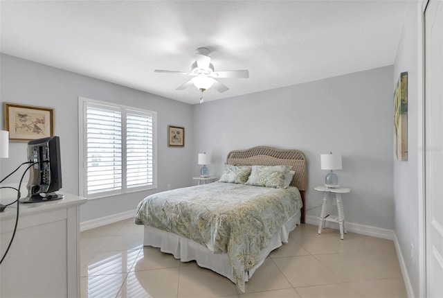 bedroom featuring light tile patterned floors, baseboards, and ceiling fan