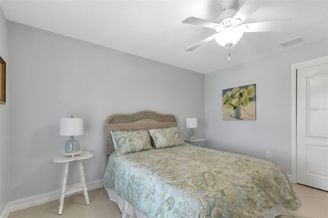 bedroom featuring light tile patterned floors, visible vents, baseboards, and a ceiling fan