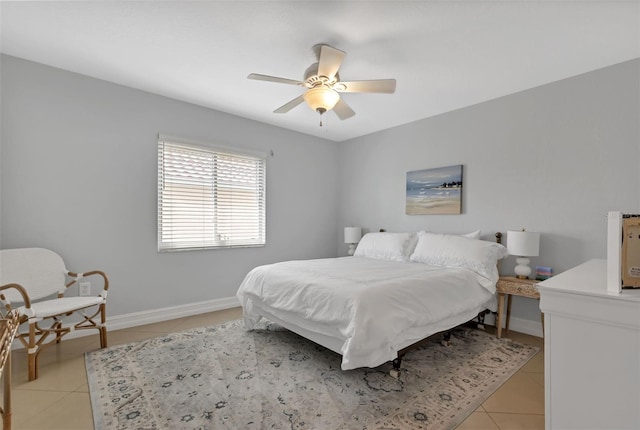 bedroom with light tile patterned floors, baseboards, and a ceiling fan