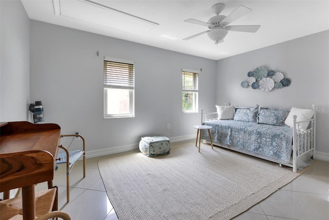 bedroom with baseboards, a ceiling fan, and light tile patterned flooring