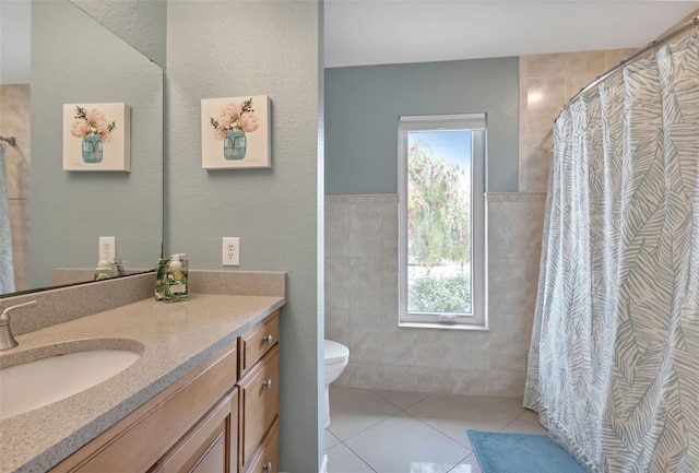 full bath featuring toilet, tile walls, tile patterned flooring, and a wealth of natural light