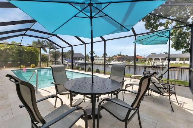 view of pool featuring a fenced in pool, a patio area, a water view, and glass enclosure