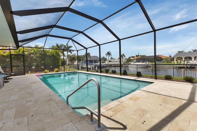pool featuring a water view, fence, glass enclosure, and a patio