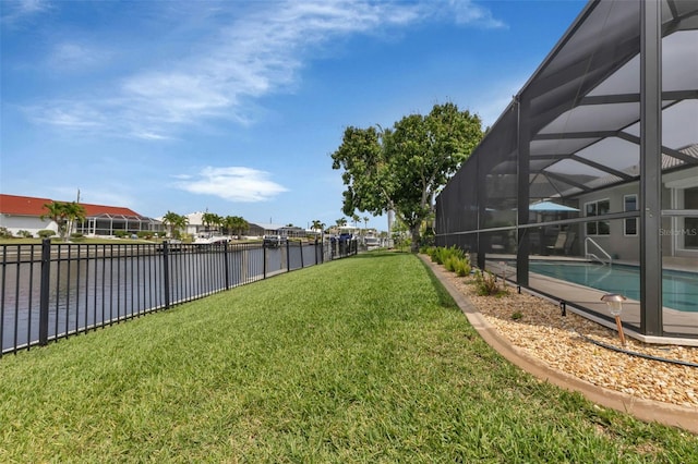view of yard featuring a water view, glass enclosure, fence, and a fenced in pool