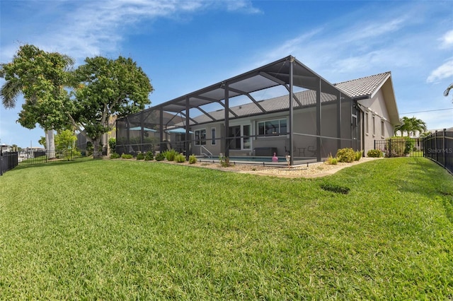 rear view of property with a yard, a fenced backyard, glass enclosure, and a fenced in pool