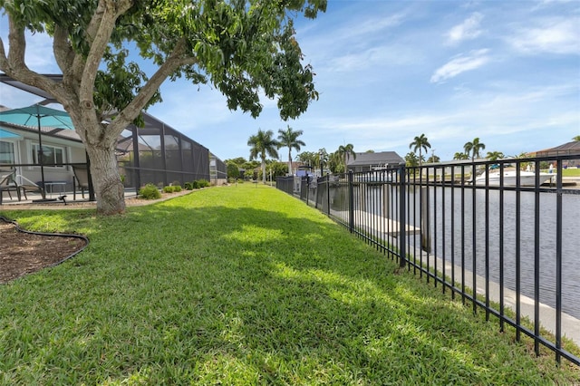 view of yard with fence and glass enclosure