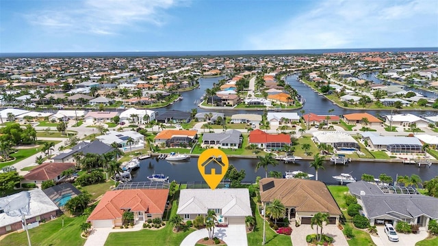 birds eye view of property featuring a water view and a residential view