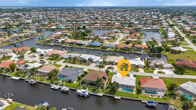 birds eye view of property featuring a residential view and a water view