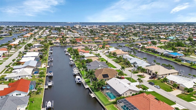 drone / aerial view with a water view and a residential view