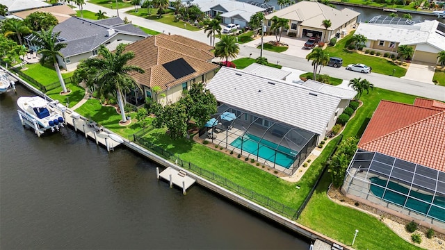 drone / aerial view with a water view and a residential view