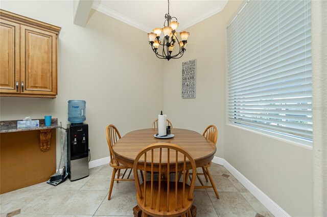 dining room featuring an inviting chandelier, light tile patterned flooring, crown molding, and baseboards