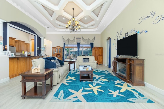 living area with a chandelier, crown molding, coffered ceiling, a towering ceiling, and arched walkways