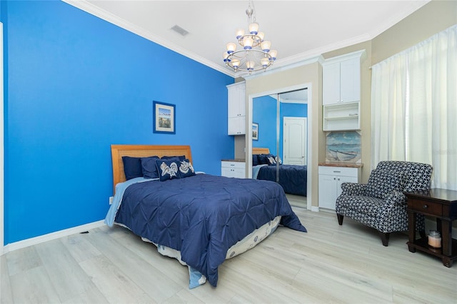 bedroom featuring an inviting chandelier, crown molding, and light wood finished floors