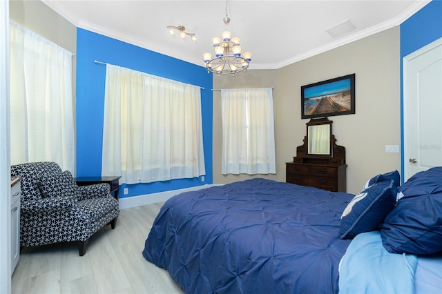 bedroom with a chandelier, visible vents, ornamental molding, and wood finished floors