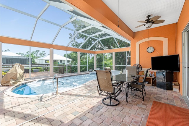 pool with a lanai, ceiling fan, a patio, and outdoor dining area