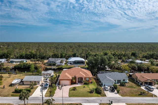 aerial view with a wooded view and a residential view