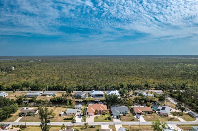 aerial view featuring a view of trees and a residential view