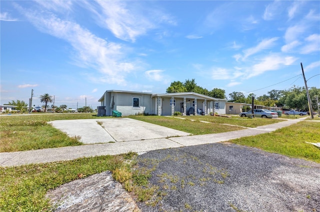 21242 Coulton Ave, Port Charlotte, FL 33952 - view of front of house featuring a front yard, a porch, concrete driveway, and stucco siding