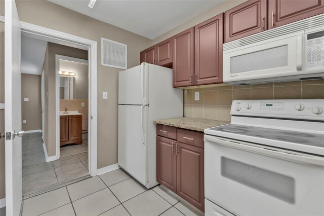 21242 Coulton Ave, Port Charlotte, FL 33952 - kitchen featuring white appliances, visible vents, light tile patterned flooring, baseboards, and backsplash