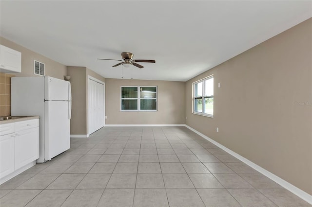 21242 Coulton Ave, Port Charlotte, FL 33952 - interior space with visible vents, baseboards, a ceiling fan, and light tile patterned flooring
