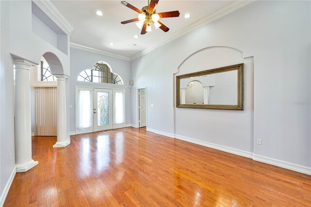8315 Raoul Ave, North Port, FL 34291 - unfurnished living room with ornate columns, ceiling fan, ornamental molding, light wood finished floors, and recessed lighting