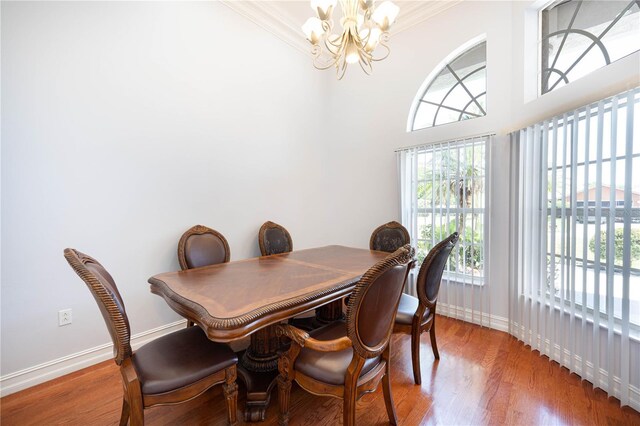 8315 Raoul Ave, North Port, FL 34291 - dining space with a chandelier, baseboards, wood finished floors, and crown molding