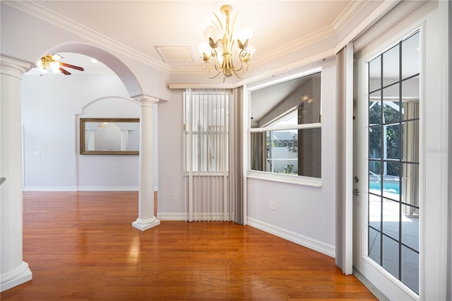8315 Raoul Ave, North Port, FL 34291 - unfurnished dining area with decorative columns, wood finished floors, a chandelier, ornamental molding, and baseboards