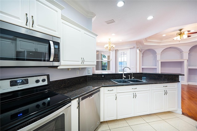 8315 Raoul Ave, North Port, FL 34291 - kitchen with stainless steel appliances, a sink, a chandelier, ornamental molding, and white cabinets