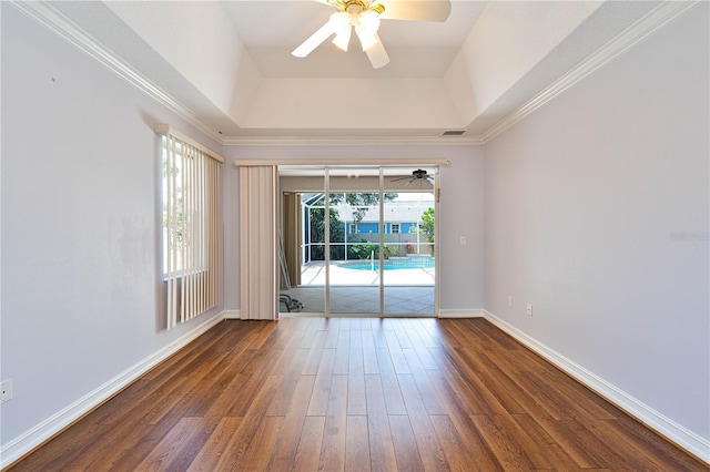 8315 Raoul Ave, North Port, FL 34291 - unfurnished room featuring a ceiling fan, dark wood-type flooring, a raised ceiling, baseboards, and crown molding
