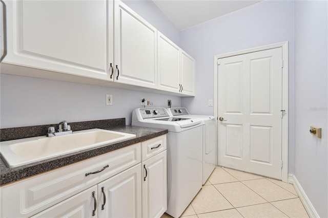 8315 Raoul Ave, North Port, FL 34291 - laundry area with washing machine and dryer, light tile patterned flooring, cabinet space, and baseboards